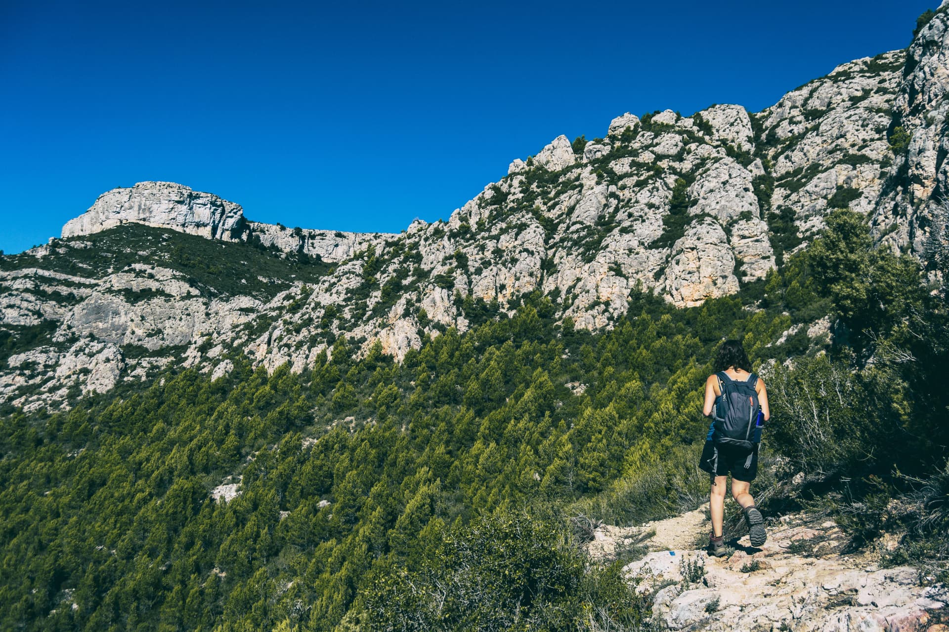 woman hiking on a mountain path in catalonia