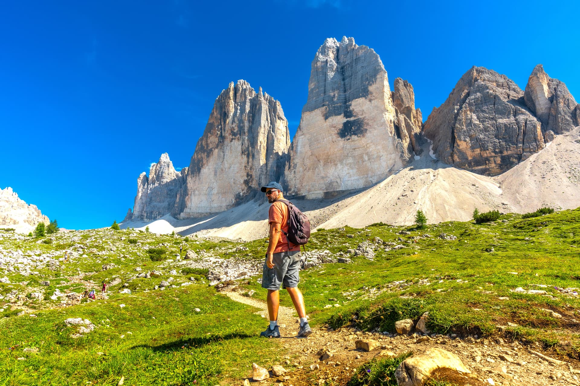 Tourist hiking on the tre cime di lavaredo trail in the italian dolomites