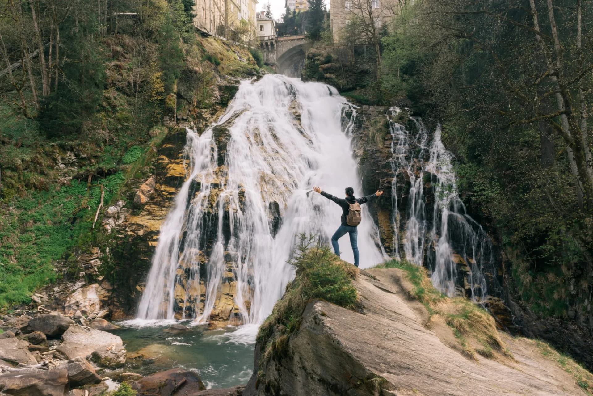 Austria. Bad Gastein. Girl at the waterfall in the Alpine mountains