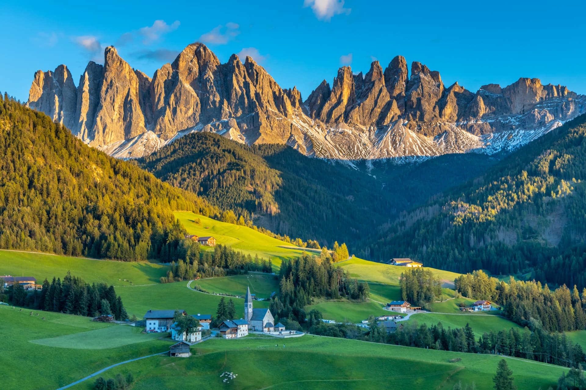 Panorama of Santa Maddalena village and church in the Dolomites, Puez Odle national park in Italy. Italian Dolomiti Alps scenic landscape in summer with beautiful sunlight at sunset