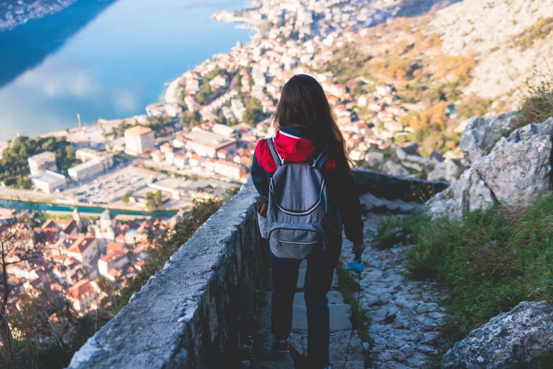 Kotor, Montenegro, process of climbing to the top of San Giovanni Fortress, Fort St. John, old medieval town, hiking on the Ladder of Kotor, sunny day with a blue sky and mount Lovcen and Orjen