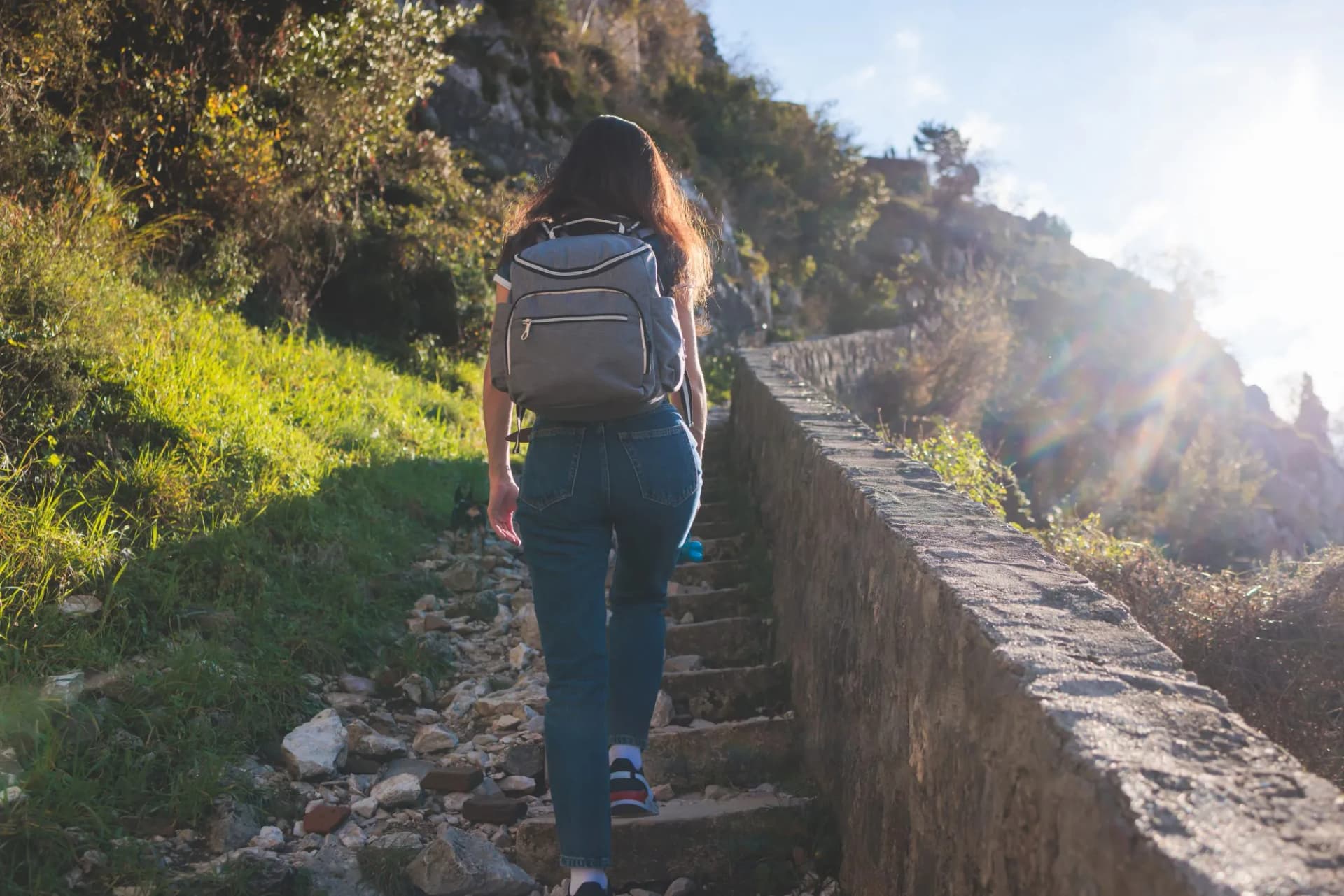 Kotor, Montenegro, process of climbing to the top of San Giovanni Fortress, Fort St. John, old medieval town, hiking on the Ladder of Kotor, sunny day with a blue sky and mount Lovcen and Orjen