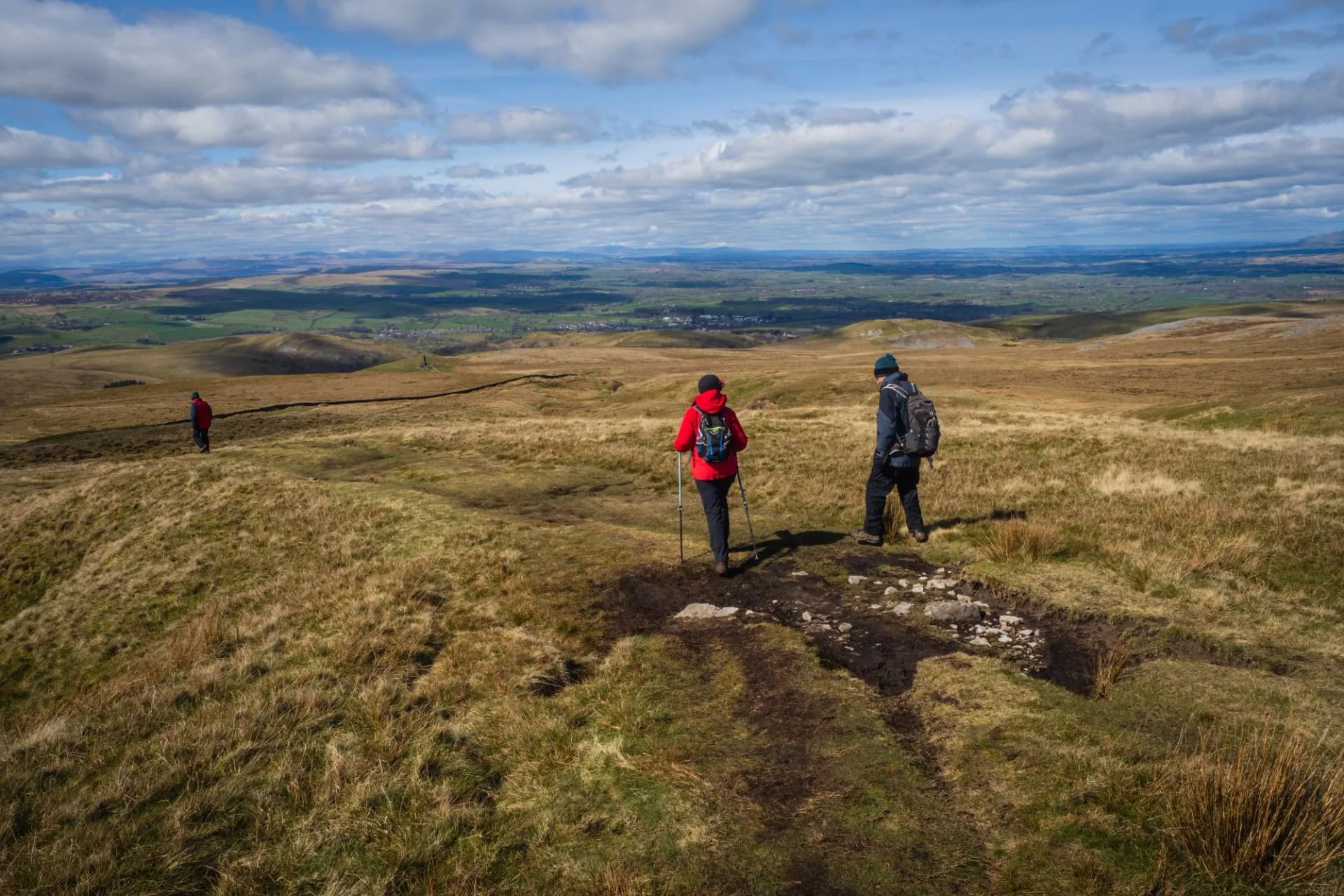 Hill walkerS descending from The Nine Standards Rigg on the Coast to Coast walk in the North Pennines near to Kirkby stephen