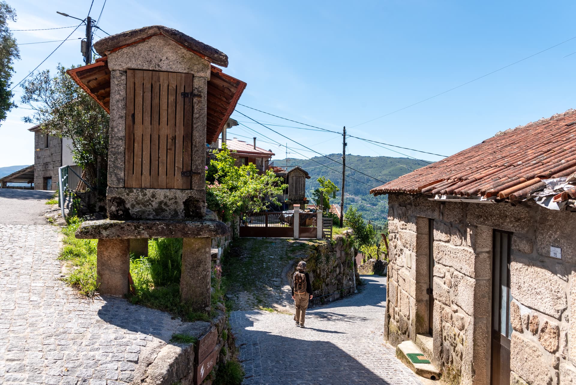 Historic stone granary on a cobblestone path in a village in Portugal.