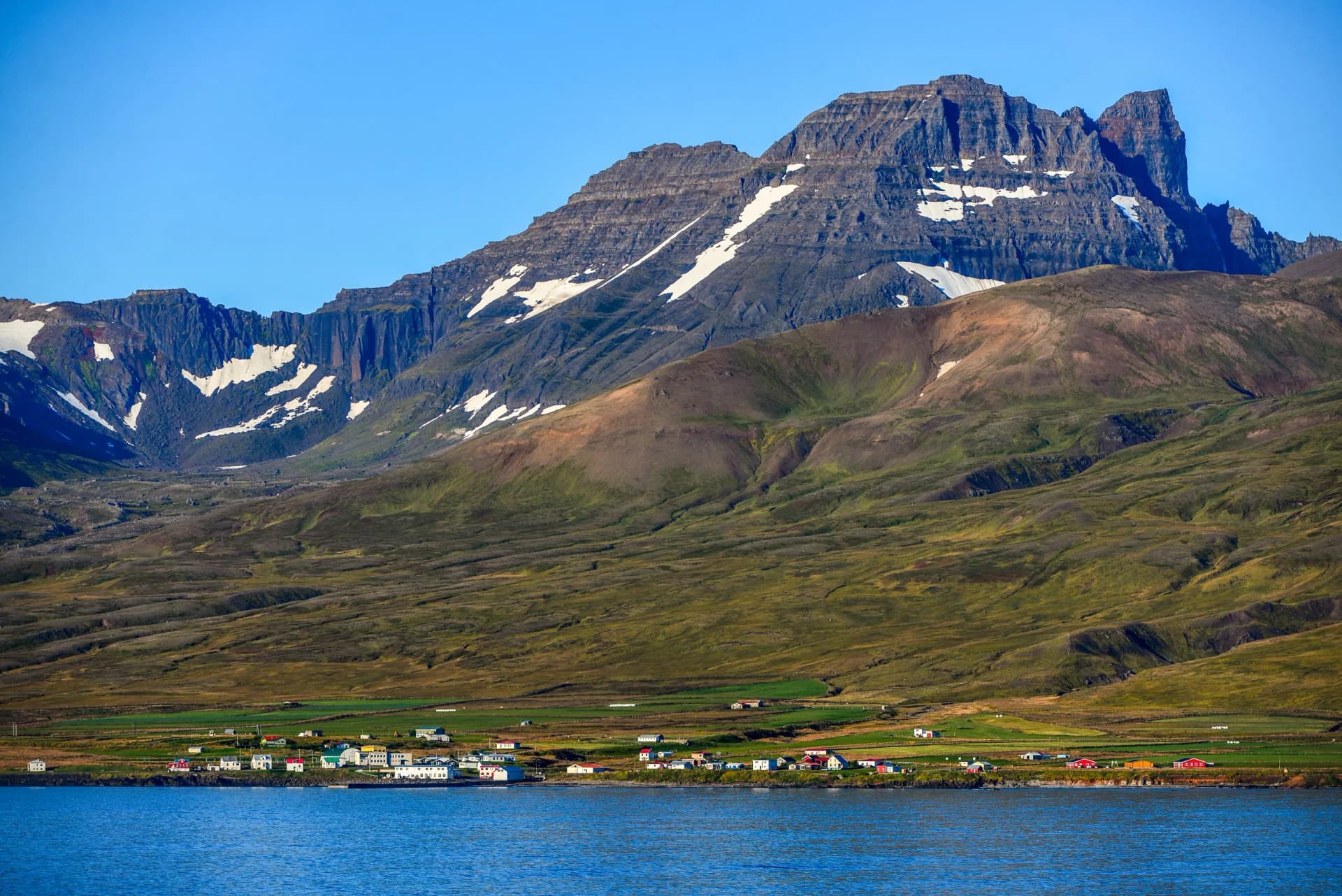 Dyrfjöll mountain towering above the small village of Bakkagerði and the fjord of Borgarfjordur Eystri, East Fjords, Iceland.