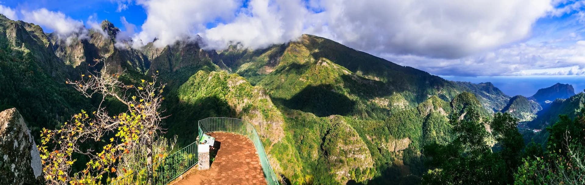 Vereda dos Balcões viewpoint overlooking lush green mountains and the distant blue sea.