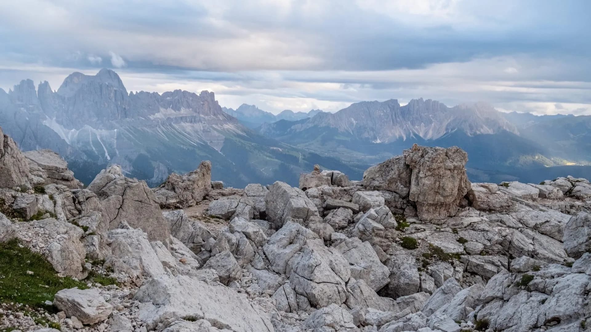 Rocky mountain summit overlooking jagged peaks under a cloudy sky from Monte Pez