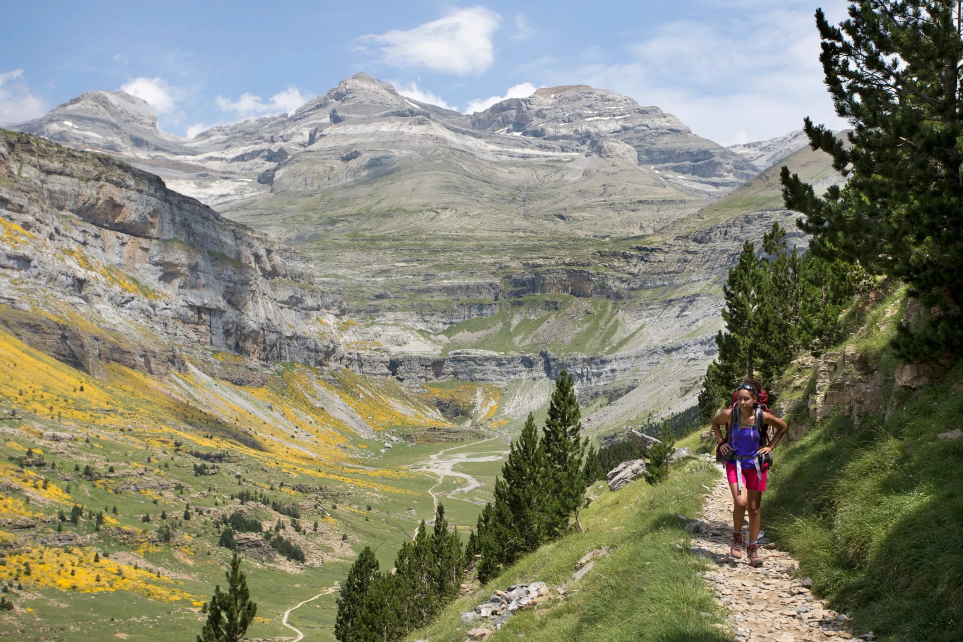 Young woman hiking in Ordesa y Monte Perdido National Park in Pyrenees, Huesca, Aragon, Spain