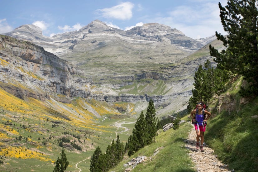 Young woman hiking in Ordesa y Monte Perdido National Park in Pyrenees, Huesca, Aragon, Spain