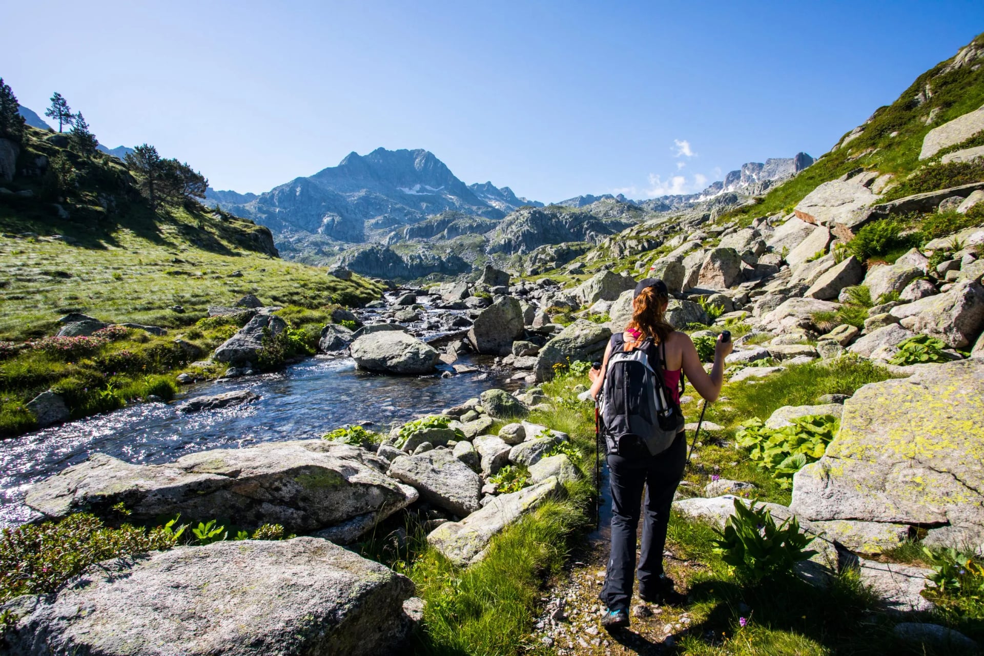 Young hiker girl summit to Ratera Peak in Aiguestortes and Sant Maurici National Park, Spain